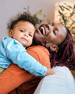 woman and baby smiling