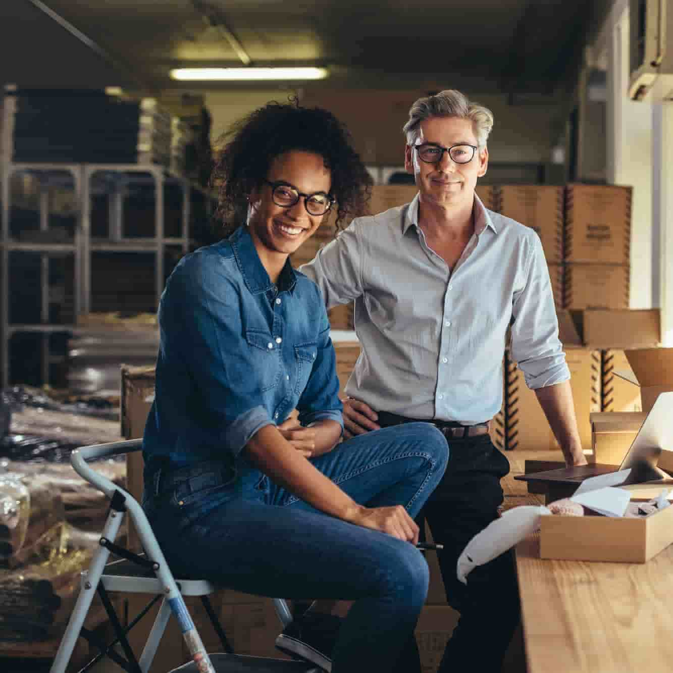 A man and a woman are working in a shipping center. 